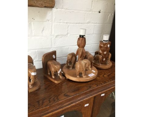 A PAIR OF CARVED ELEPHANT LAMP BASES AND MATCHING BOOK ENDS
