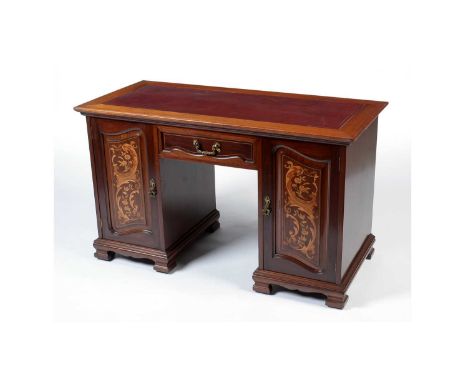 A late Victorian inlaid mahogany pedestal desk in the Arts &amp; Crafts taste, the rectangular top inset with a leather writi