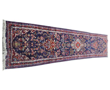 A Nahavand runner, with floral medallions, bouquet and vases, 409 x 76cms.