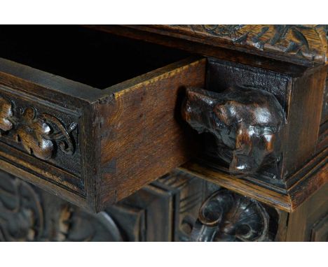 A richly carved Victorian oak side/pier cabinet with a sporting theme, the rectangular top with carved and moulded lunette bo