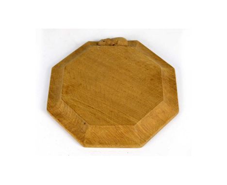 Workshop of Robert ‘Mouseman’ Thompson (Kilburn): an oak octagonal small chopping board or teapot stand, moulded edge, with c