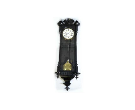 A Vienna ebonised wall clock, the enamelled roman dial with two train movement and deadbeat escapement striking on the hour a