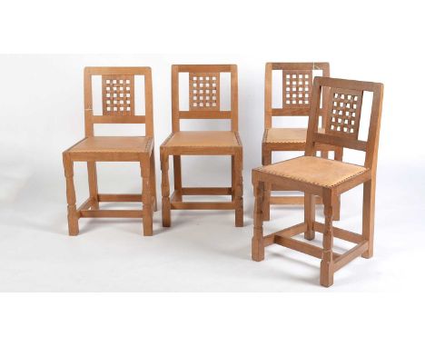 Workshop of Robert ‘Mouseman’ Thompson (Kilburn): four oak lattice back chairs, studded cow-hide seats, on two octagonal turn