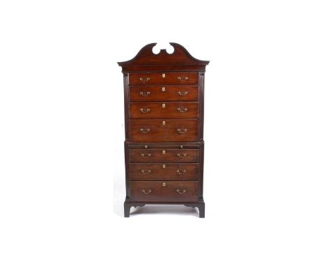 A George III mahogany chest on chest, with shaped pediment above a cavetto frieze, the upper section with four long graduated