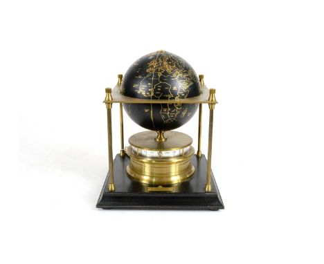 A Royal Geographic carved Geographical Society World clock, with rotating terrestrial globe within a gilt metal chassis, on a