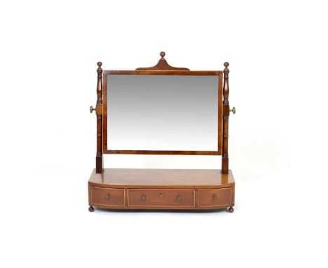 An early 19th Century mahogany swing toilet mirror, with rectangular plate, ring turned uprights, the bow front base fitted w