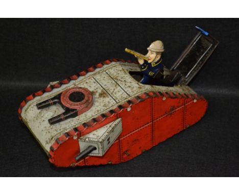 A German tinplate clockwork model of a British tank, pop-up rifleman, the wheels inscribed Dunlop 450 X 125, 24cm long, c.192