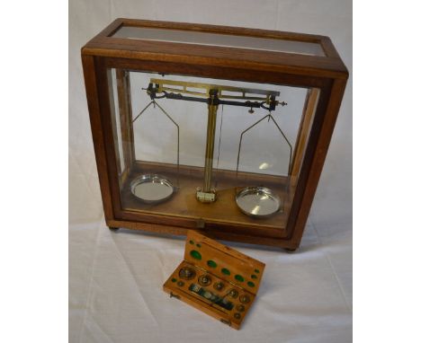 Cased set of balanced scales with a set weights