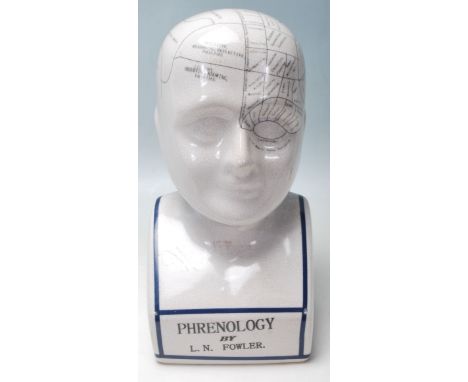 A reproduction Victorian ceramic Phrenology head having a crackle glaze with black lettered sectional labels, the base readin