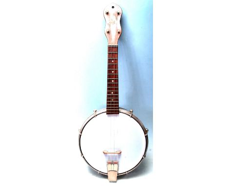 A George Formby a mid 20th century vintage ukulele with facsimile signature to the wooden neck, metal chrome face ring. Measu