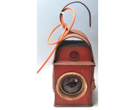 A vintage 20th century original Kenyons railway lamp with serilight lens finished in red colour way complete with oil burner.