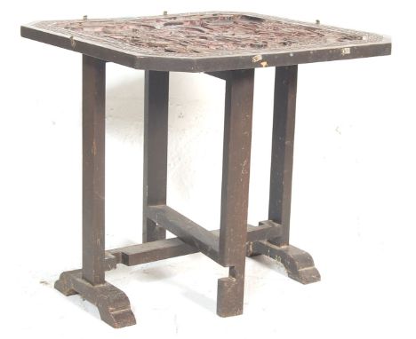 An early 20th century antique Chinese folding coffee table having carved Chinese motifs to top, folding base and tilt top con