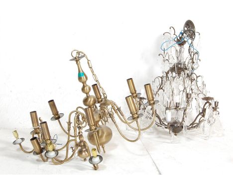 Two 20th century contemporary chandeliers comprising of a faux bronze chandelier with scrolled arms along with a blacksmith s