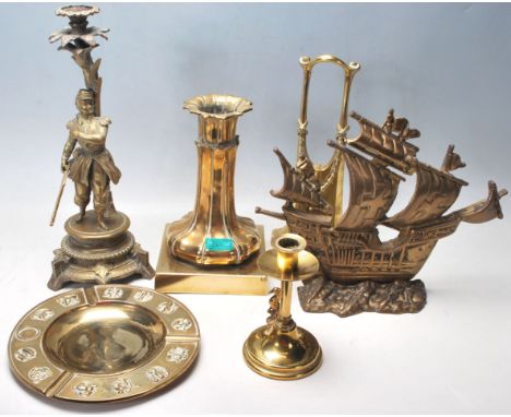 A collection of vintage 20th century brass items to include a heavy brass candlesticks in a shape of french solder mounted&nb