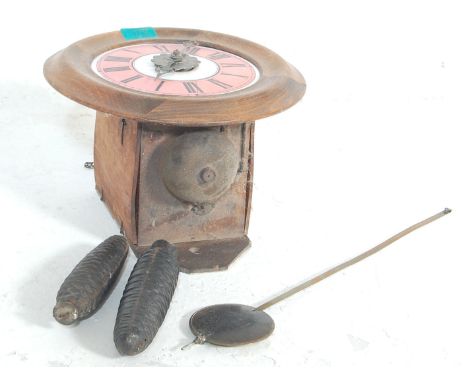 An antique style postman's clock having a oak frame with a pink face, Roman numerals to the chapter ring, brass hands and pin