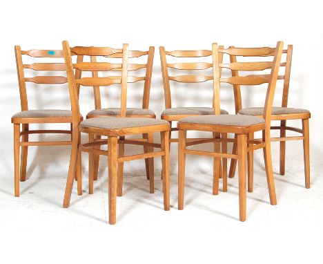 A set of six blonde wood retro kitchen chairs / dining chairs having curved ladder backrests with vinyl padded seats raised o