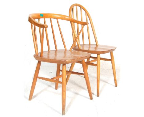 A pair of vintage Danish inspired / Ercol style blonde elm dining chairs having spindle backrest, saddle seats and turned sup