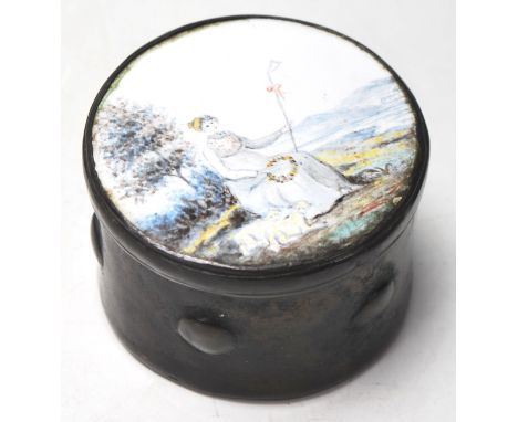 A 19th Century Georgian metal patch box having a metal body with enamelled lid decorated with a seated female figure holding 