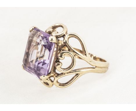 A 9ct gold amethyst dress ring, the step cut amethyst in four claw setting on a pierced scroll shank, ring size N, 6.6g 