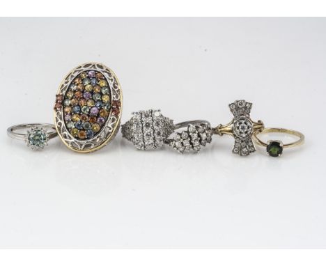 A collection of gem set silver rings, including an Art Deco style fan with silver gilt shank, a teal cluster ring, a large mu