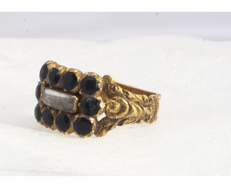 A 19th century mourning ring,  the central plaited hair panel, with over laid colourless paste, surrounded by a bezel of Fren