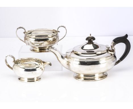 A George V silver three piece tea set from D &amp; B, Art Deco style oval teapot, sugar basin and milk jug, some wear and min