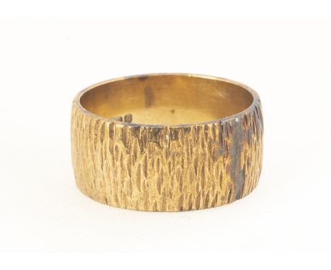 A 9ct gold wedding band, of flattened textured form, ring size L 1/2, 8.8mm, 5.4g 