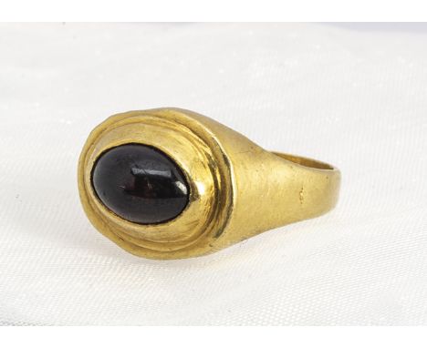A late 18th early 19th century garnet signet ring, the cabochon garnet in raised setting, ring size J, 5.9g 