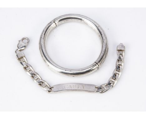 A silver identity bracelet, marked Carly, dated to reverse 9-10-99 on a curb link chain, 19cm together with a silver circular