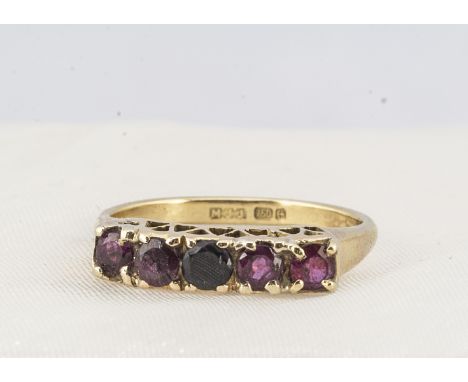 An 18ct gold five stone ruby dress ring, the circular round mix cut stone, in claw setting, pierced gallery, ring size O, 4.6