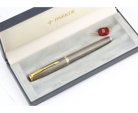 A modern Parker Sonnet silver fountain pen, silver and black enamel with gilt clip, 18ct gold nib, unused, boxed 