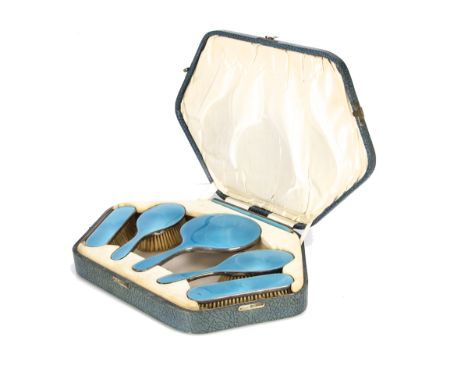 A cased Art Deco silver and enamelled six piece dressing table set by AC, the hexagonal fitted box with hand mirror, pair of 