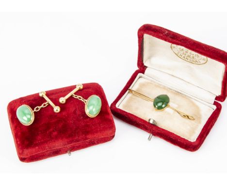 A Chinese jadeite jade oval cabochon yellow metal bar brooch, cased, cabochon 1.5cm x 1.2cm, together with a pair of Chinese 