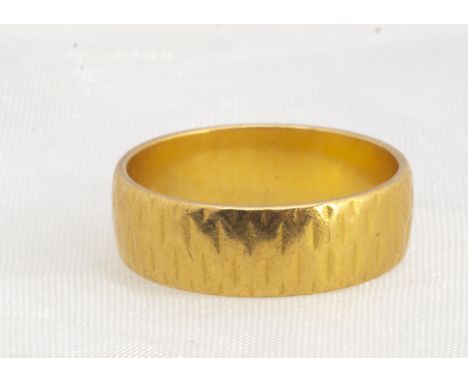 A 22ct gold wedding band,  of flattened form with textured shank, ring size M1/2, 6 mm wide, 5.7g 