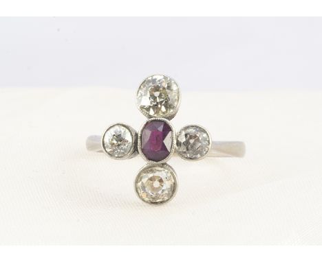 A ruby and diamond cruciform ring, the central oval ruby 0.40ct, surrounded by four old cut diamonds approximate weight 0.80c
