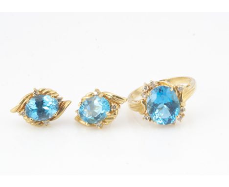 A 14ct gold blue topaz and diamond ring and earring set, the decorative crossover style ring, ring size P, 9.3g 