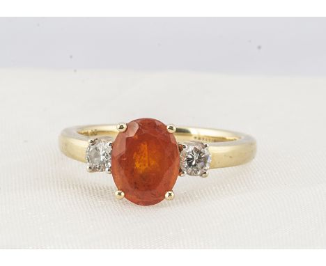 An 18ct gold three stone fire opal and diamond ring, the oval mixed cut opal in four claw setting, flanked by a pair of brill