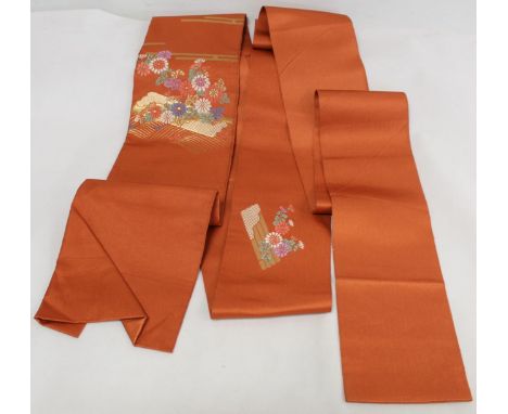 Japanese Obi sash of orange silk with brocade small panels of flowers in polychrome and gold threads, approximately 356cm lon