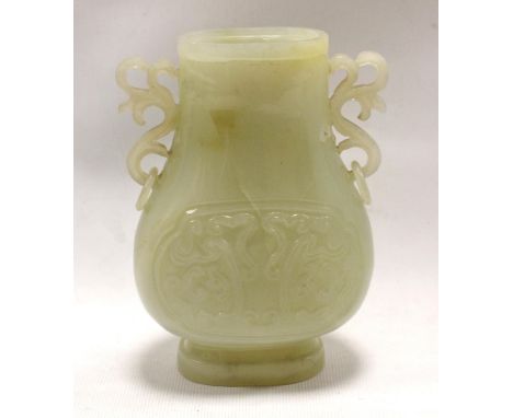 Chinese pale green hardstone vase of twin-handled oval baluster form with two carved archaic panels, foliate scroll ring hand