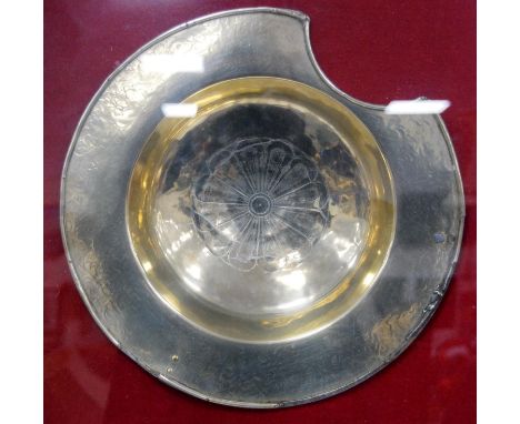 Antique brass barber's shaving bowl, 35cm diameter, enclosed in a later glazed wall-hanging display case, overall 69cm x 68cm