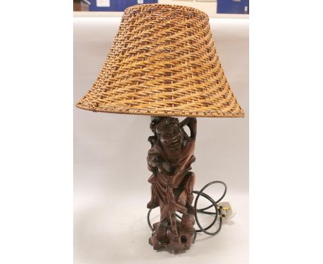 Chinese carved fruitwood table lamp base depicting the emaciated deity standing on a naturalistic pierced base with cockerel 