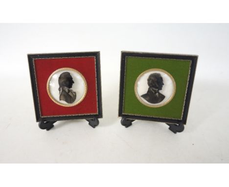 PAIR OF HANDPAINTED PORTRAIT SILHOUETTES
of Mozart and Schubert, on convex glass, 7.3cm diameter, mounted in square frames