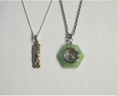 JADE AND SILVER PENDANT with spinning dolphin within the central panel, and a sapphire set silver pendant, both on silver cha