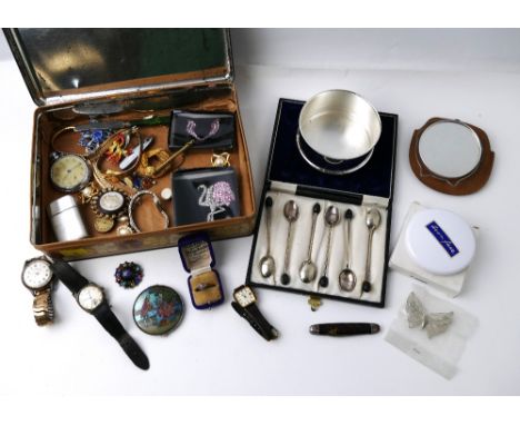 Vintage tin containing costume jewellery, watches, brooches, lighter, and a cased set of silver plated coffee spoons  