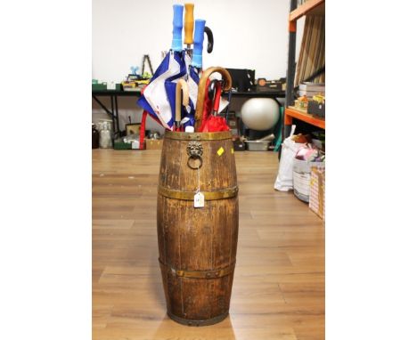 Oak and brass bound barrel formed stick stand, 68 cm high with quantity of umbrellas