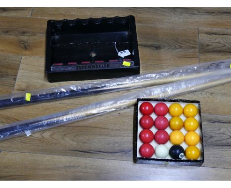 Two snooker cues, set of snooker balls and three wheeler cue stand