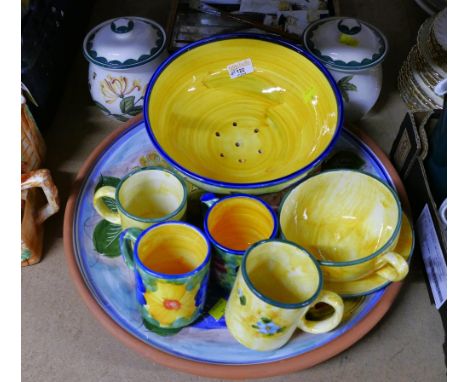 Collection of floral patterned ceramic dishes and mugs