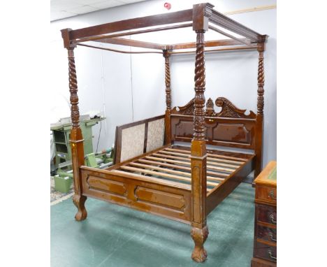 Heavily carved ornate four poster bed.