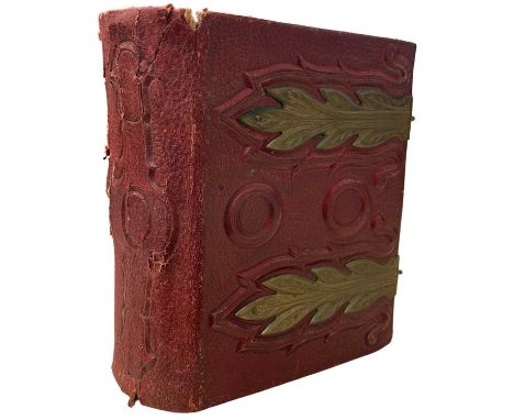 A small red leather and brass Victorian photograph album, containing approximately 45 black and white portrait photographs.