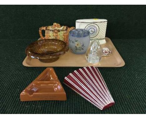 A tray of Wedgwood contrasts china mantle clock, an Arthur wood teapot, glass paperweight, miniature Indian tree trio, Armita